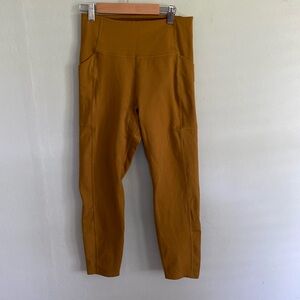 Girlfriend Collective dark mustard color leggings with pockets size Medium